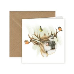 A deer greeting card featuring a deer with birds perched on its antlers, surrounded by a nature scene with trees in the background. The card is 13 x 13 cm in size and belongs to the "Cards with Pictures" category.