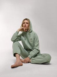  A green women's hoodie with raglan sleeves.