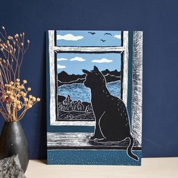 A black cat silhouette sitting in a window frame, with a scenic landscape visible through the window. The image has a vintage, woodcut-style aesthetic.