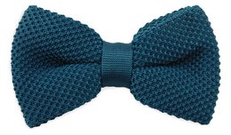 A knitted petrol blue bow tie with a textured pattern and a solid blue band.