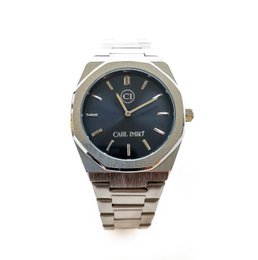 A stainless steel watch with a black dial and a date display. The watch has a classic, minimalist design suitable for everyday wear.