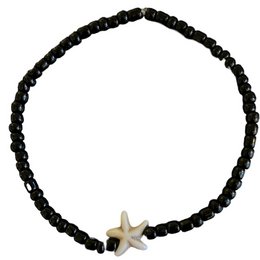 Black beaded anklet with a starfish charm. Made of black beads and a gold starfish charm.