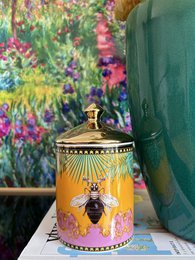 Scented candle with hand-cut glass jar in a dark amber color, featuring a textured honeycomb pattern.
