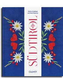 Cookbook featuring traditional South Tyrolean cuisine and recipes, with colorful floral design on the cover.