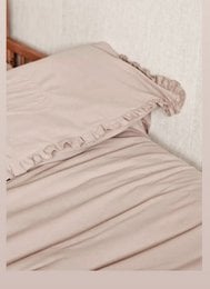Soft, ruffled duvet cover in beige, olive, mauve, and off-white colors, available in sizes for crib, toddler, and twin beds.