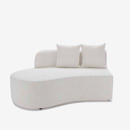  A white, curved sofa module with a terry cloth upholstery and two throw pillows. The sofa has a modern, minimalist design and would be suitable for a living room or lounge area.