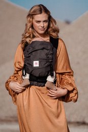 Gray baby carrier with adjustable straps and padded back support for comfortable babywearing.