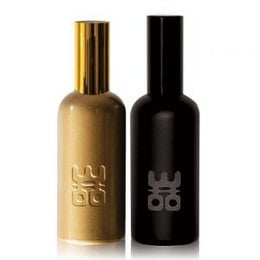 Two 50ml room spray bottles in gold and black colors with the brand name "WOO" printed on them.