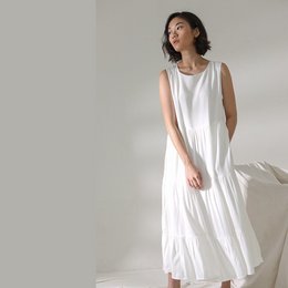 Sleeveless midi dress in white, black, olive, and sage colors. Made of lightweight, flowing fabric for a comfortable, elegant look.