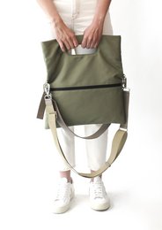 Olive green tote bag with multiple compartments and adjustable strap for versatile carrying.