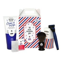 A shaving set for men containing a shaving brush, shaving cream, and other grooming essentials in a retro-styled box. The set includes a blue and white striped box with a vintage-inspired design, featuring a shaving brush, shaving cream, and other grooming products.