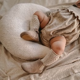 Taupe-colored Chelsea boots for babies, available in sizes 18-21. The boots feature a rounded toe and a textured fabric upper, providing a comfortable and stylish option for young feet.