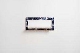 Indigo blue patterned floating wall shelf with white surface, suitable for storage and display.
