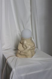 A handmade, matte gray vase with a simple, cylindrical shape.