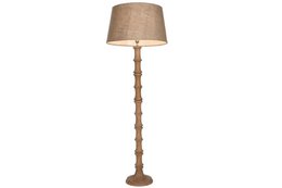  Tall, carved wooden floor lamp with a beige fabric shade.