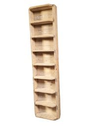 Rustic wooden wall shelf with multiple compartments for storing and displaying various items.