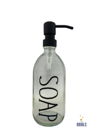 A transparent glass soap dispenser with a black pump and the word "SOAP" printed on the bottle in a premium design. The dispenser has a capacity of 500ml.