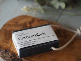 Black soap bar with rope, made from natural ingredients.