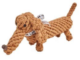A round, braided dog toy made of natural fibers.