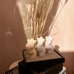 Curvy, vegan soy wax candle in pearl, cream, peach, rosy, dove, and dusky colors. Sculptural, feminine shape.