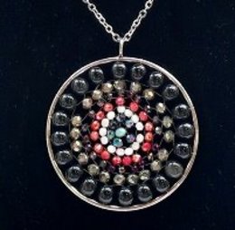 Mandala necklace with onyx beads, featuring a circular pendant with a colorful, intricate design.