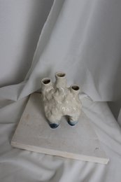 A handmade, matte gray vase with a simple, cylindrical shape.