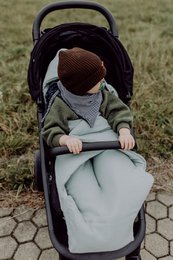  Soft, cozy muslin baby blanket in a soothing grey-blue and pastel green color palette, perfect for swaddling and keeping your little one warm and comfortable.