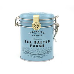 A round, tall tin canister containing sea salted fudge. The canister is light blue in color with a metal clasp closure and a gold-colored label.