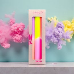 Tall, neon-colored candles in shades of pink, yellow, and orange. The candles have a dip-dyed effect, creating a vibrant, summer-inspired look.