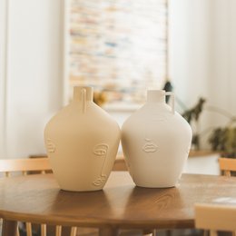 Beige and white ceramic amphora vases with minimalist designs, suitable for home decor and floral arrangements.