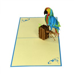 Colorful 3D pop-up card featuring a vibrant parrot perched on a suitcase, perfect for spring and summer occasions.