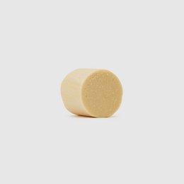  Solid, round conditioner bar made of natural ingredients for moisturizing hair.