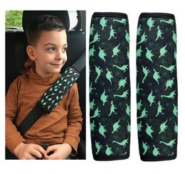 The product is a car seat belt protector for kids, featuring a dinosaur design. The product comes in 1 or 2 dinosaur variants and the description includes the relevant details such as the colors, patterns, and shapes present in the design.
