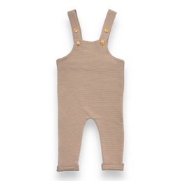 Taupe ribbed baby overalls with snap buttons on the straps. Made of soft, comfortable material suitable for everyday wear.