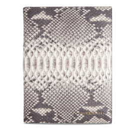 A natural-colored notebook with a snakeskin-patterned cover.
