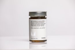 Raw honey in a glass jar with a silver lid. The honey is a light golden color.