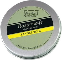 Sandalwood-scented shaving soap in a round tin container. The soap is white in color and has the brand name "Hans Baier" embossed on the surface.