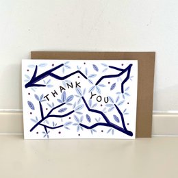 A thank you card with a navy blue and white abstract design featuring branches and leaves.