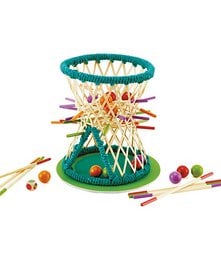 A colorful, circular game board with various wooden shapes and pegs in a variety of colors. The game appears to be a shape-sorting or stacking activity, suitable for children.