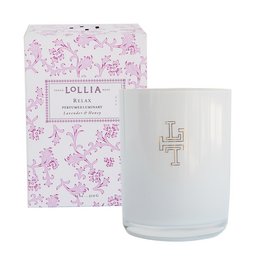 A tall, round white candle with a floral pattern printed on the glass container. The candle is labeled "Lollia Relax Luminary" and is a scented candle.