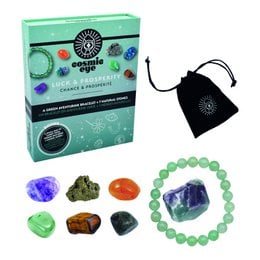 A green gift box with a cosmic eye design, containing various crystals and stones for luck and prosperity.