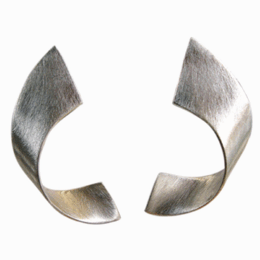 Silver ear studs with a curved, angular design made of metal. The studs have a modern, minimalist aesthetic.