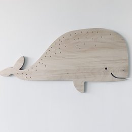 Wooden whale-shaped decoration for kids' room, available in two sizes - grand format and petit format. The decoration features a simple, minimalist design with a natural wood finish and a playful whale shape, suitable for decorating a child's bedroom or nursery.