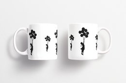 A white ceramic mug featuring the iconic Banksy artwork of a girl floating away with balloons. The mug has a simple, minimalist design with the Banksy graffiti-style image printed in black.