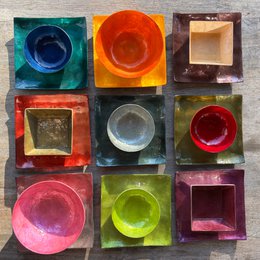  Decorative Capiz Shell Square Sushi Plates in a variety of vibrant colors including olive, yellow, green, purple, rust, lilac, turquoise green, prune, and smoke. These premium handcrafted plates are perfect for serving sushi or other small dishes.