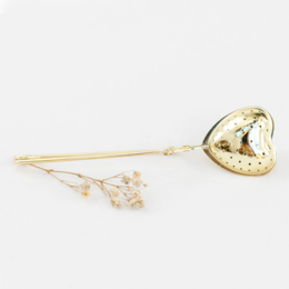 Gold heart-shaped tea tongs with delicate floral accents, perfect for infusing tea with style.