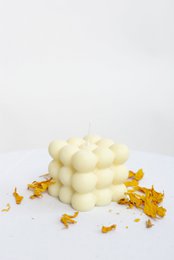 Cube-shaped pillar candle with a bubble-like texture, available in classic, baby, and set variants.