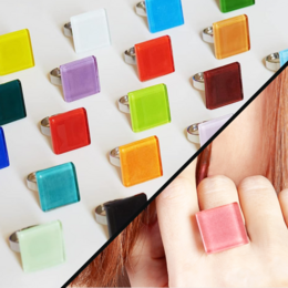 A square statement ring with an adjustable size and available in 20 different colors, including sandbraun, sandrosa, orange, malachitgrün, graphitgrau, and more. This upcycled jewelry piece features a stone accent and is a bold, fashionable accessory.