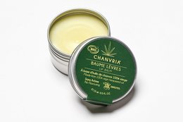 Organic hemp lips balm in a 15 ml tin container. Green and white label with hemp leaf design.
