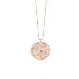 'State your Passion necklace, a delicate gold-plated charm necklace with a round pendant featuring an intricate floral design. The necklace is available in three metal variants: yellow gold, rose gold, and sterling silver.'

The State your Passion necklace is a delicate charm necklace featuring a round pendant with an intricate floral design. The necklace is available in three metal variants: yellow gold-plated, rose gold-plated, and 925 sterling silver. The pendant has a textured, medallion-like appearance and hangs from a fine chain. This necklace is a versatile accessory that can complement a variety of outfits and personal styles.